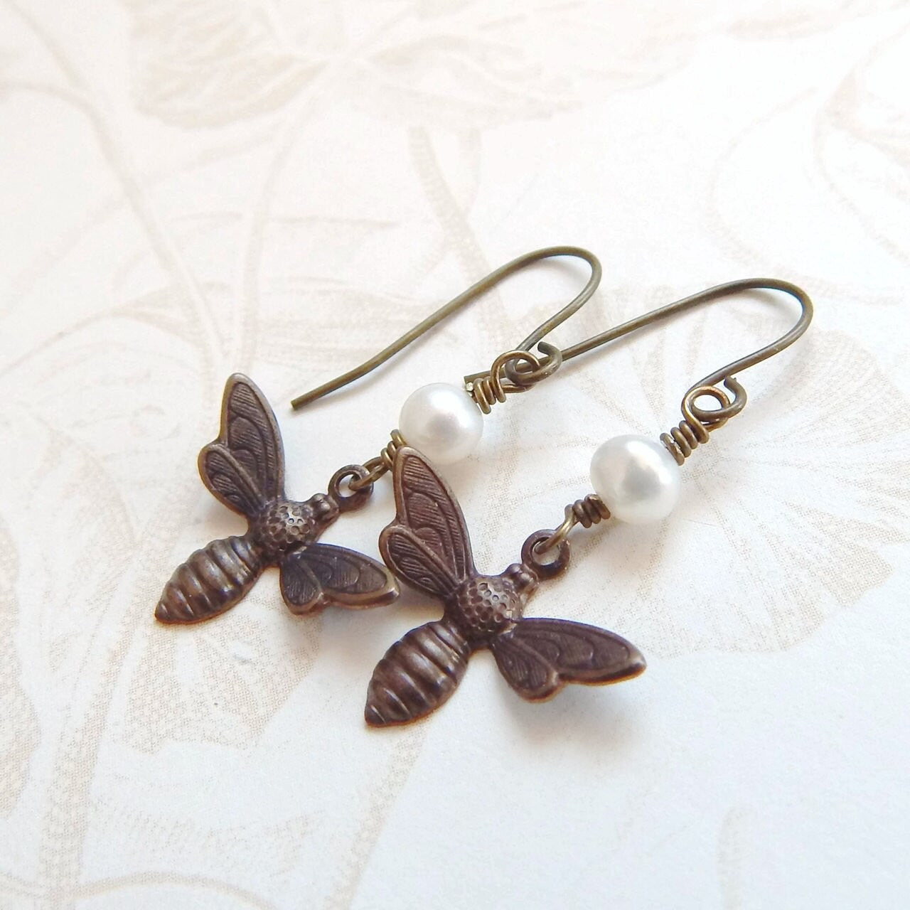 Bee charm earrings with white pearls
