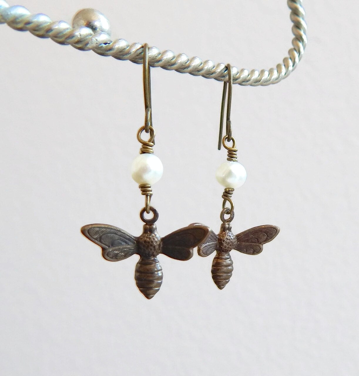 Bee charm earrings with white pearls