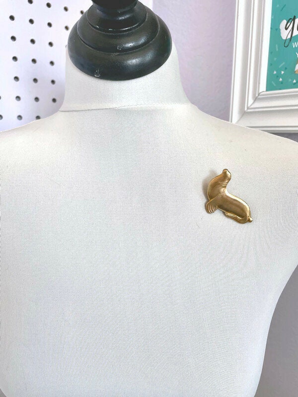 Fred - vintage brass seal brooch