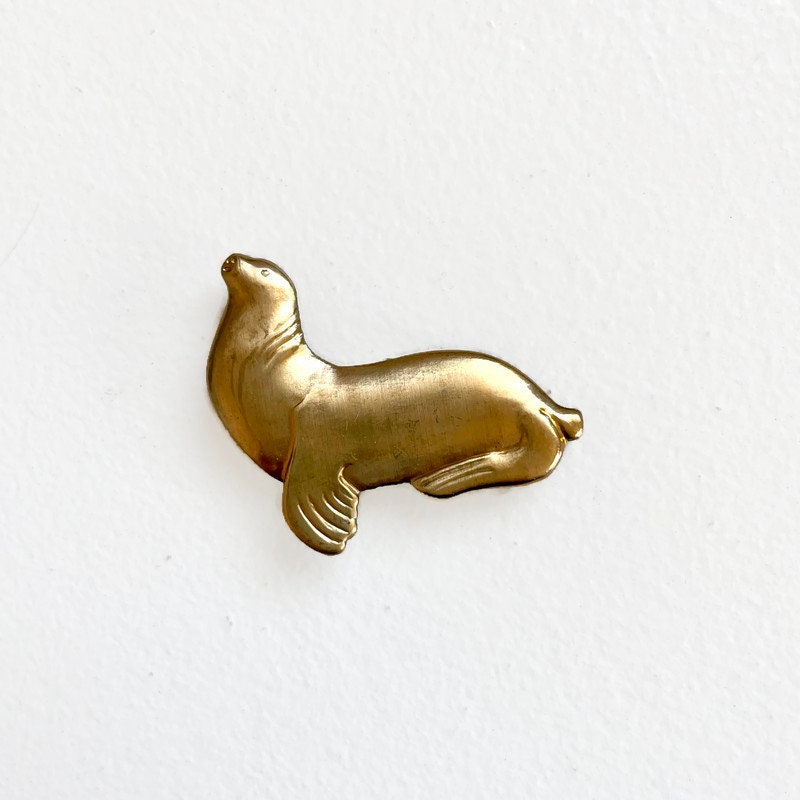 Fred - vintage brass seal brooch