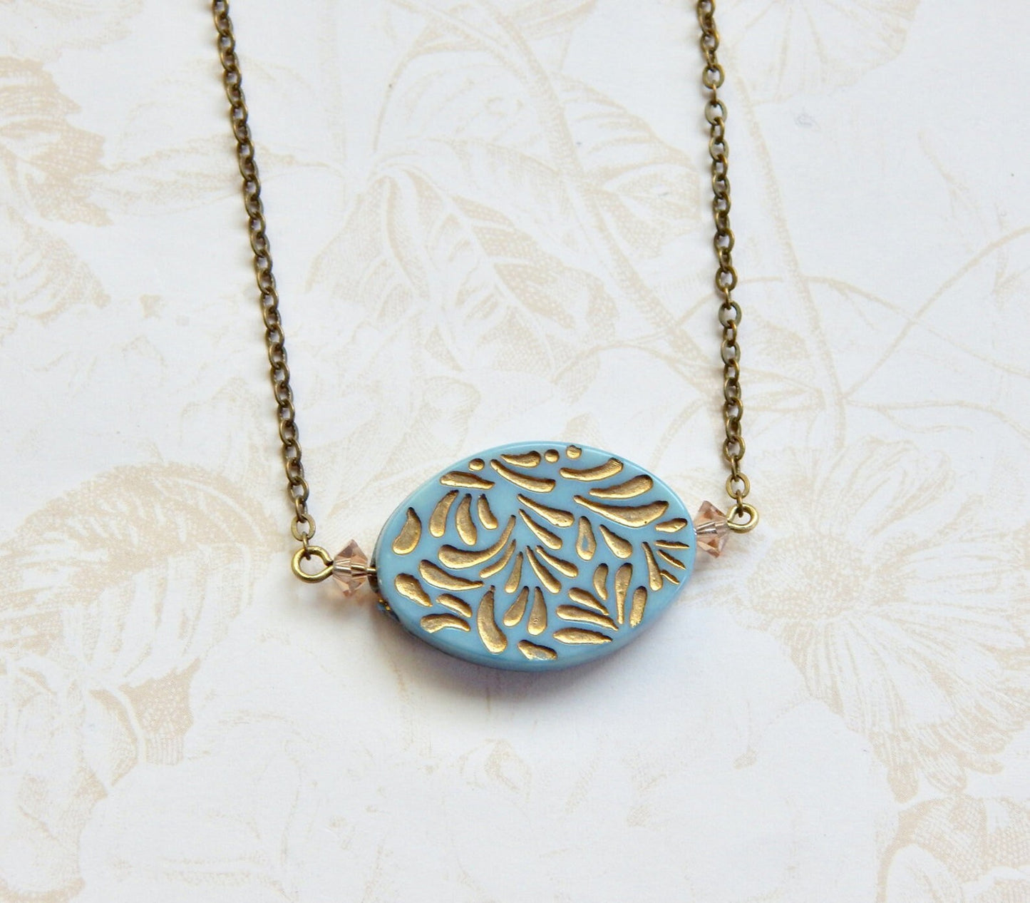 Gold etched pendant necklace in pink or blue