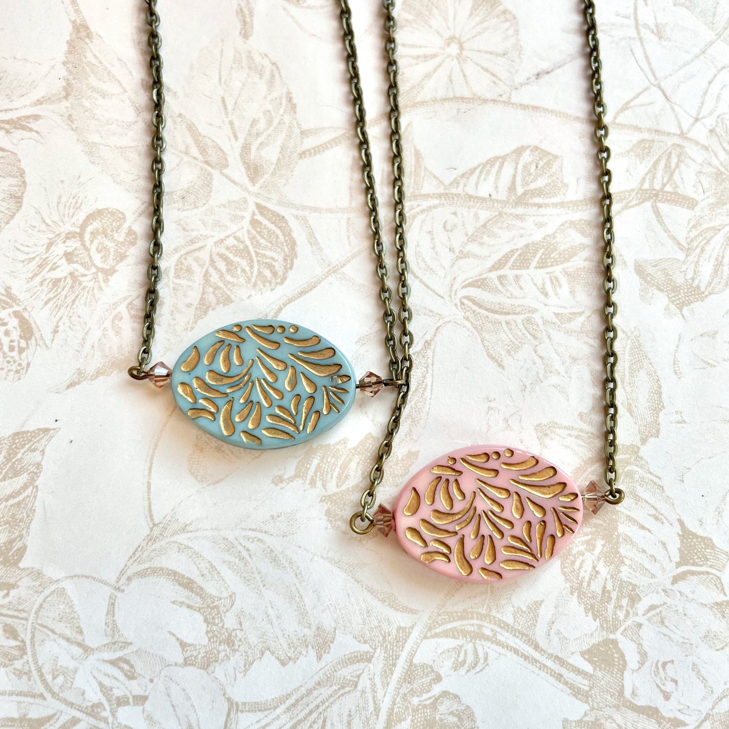 Gold etched pendant necklace in pink or blue
