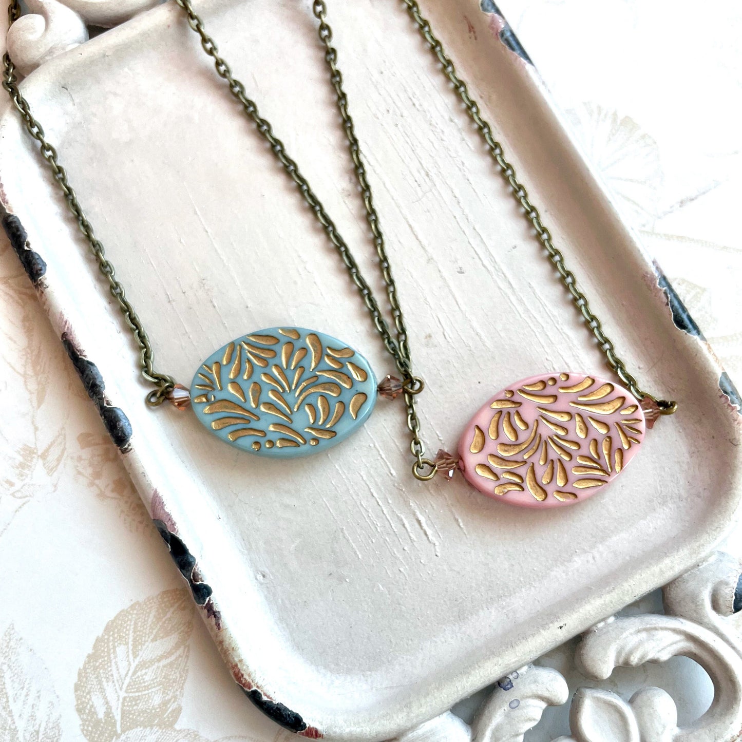 Gold etched pendant necklace in pink or blue